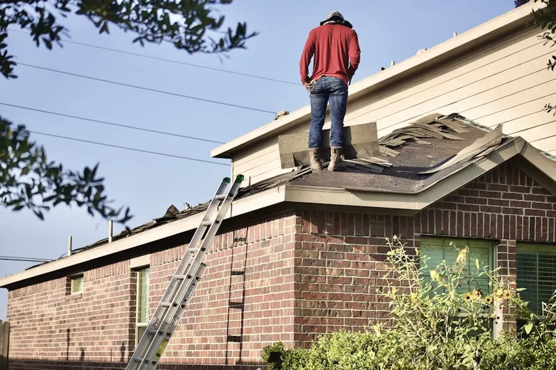 Professional roofer working on a residential roof in Fort Bend Houston